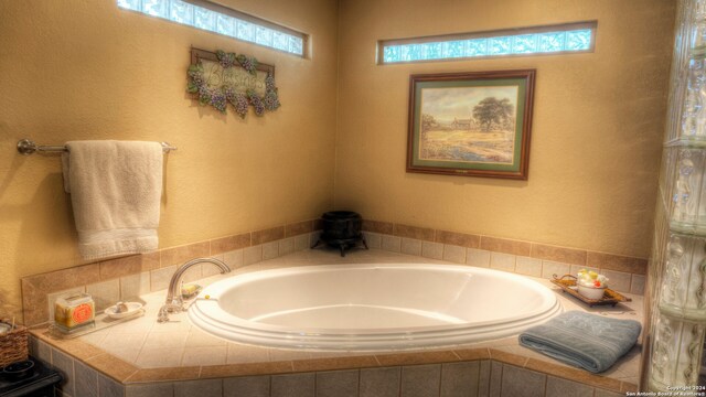 bathroom with tiled tub