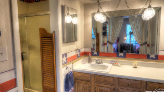 bathroom featuring oversized vanity and walk in shower