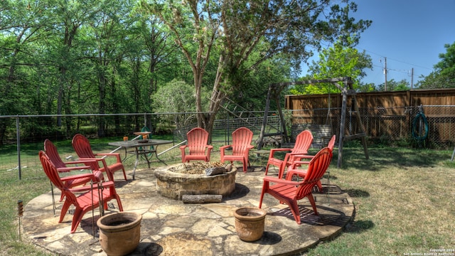 view of terrace with an outdoor fire pit