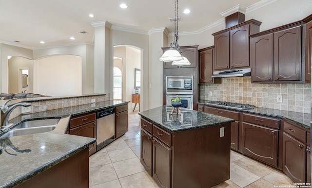 kitchen with dark brown cabinets, sink, decorative light fixtures, and appliances with stainless steel finishes