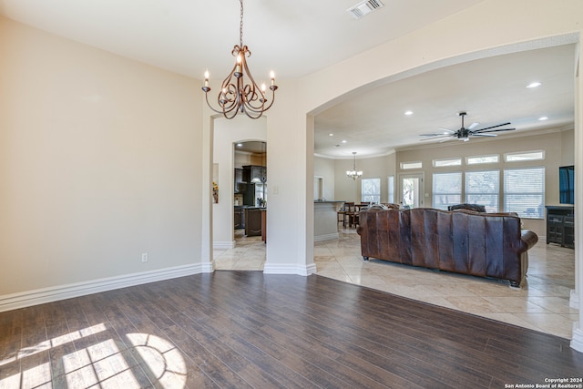 living room featuring ceiling fan with notable chandelier