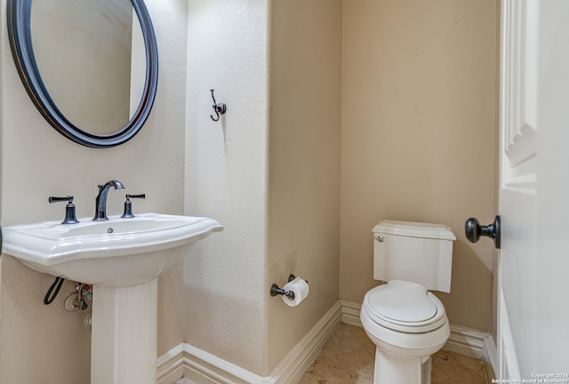 bathroom with tile patterned floors, sink, and toilet