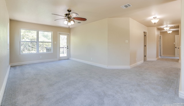 unfurnished room with light colored carpet and ceiling fan