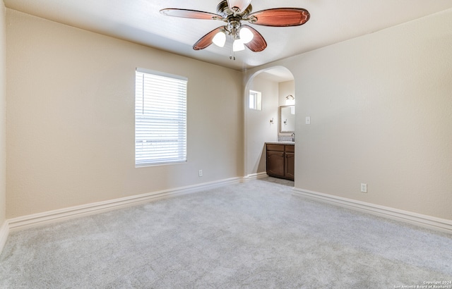 spare room with light colored carpet and ceiling fan