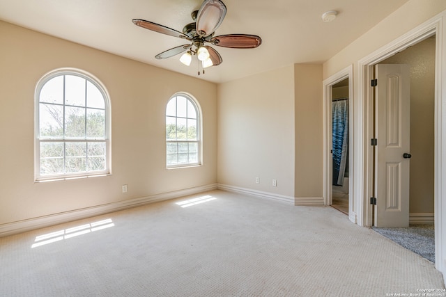 carpeted empty room featuring ceiling fan