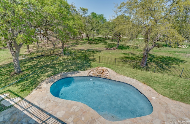 view of swimming pool featuring a yard and a patio area