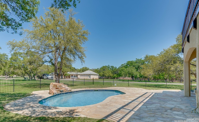 view of swimming pool with a lawn and a patio