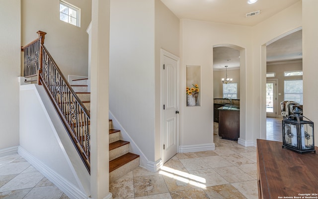 stairway with crown molding and sink