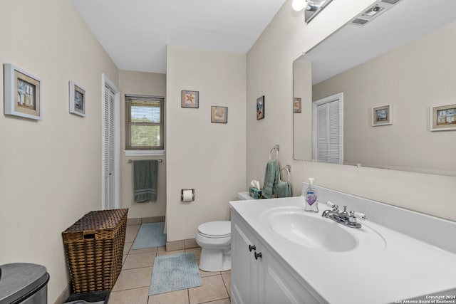 bathroom with vanity, tile floors, and toilet