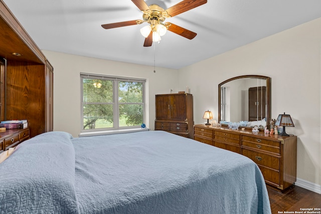 bedroom with ceiling fan and dark hardwood / wood-style flooring