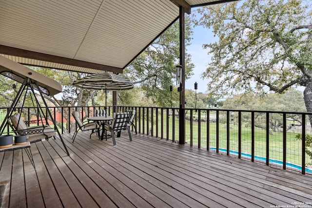 wooden deck with a lawn