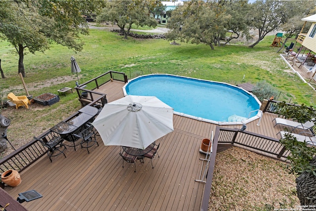 view of pool with a yard and a wooden deck