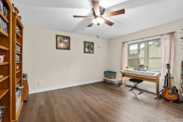 misc room with dark wood-type flooring and ceiling fan