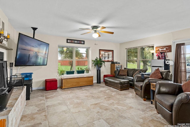 living room with light tile floors, ceiling fan, and a healthy amount of sunlight