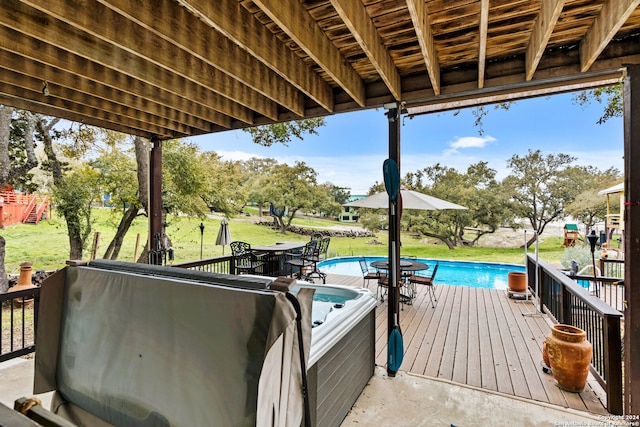 view of patio / terrace with a pool with hot tub