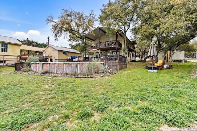 view of yard featuring a wooden deck and an outdoor fire pit