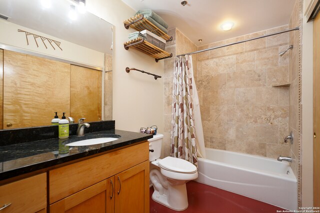 full bathroom with toilet, shower / tub combo, and vanity with extensive cabinet space