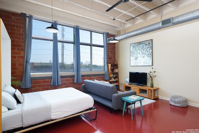 bedroom with concrete floors and brick wall