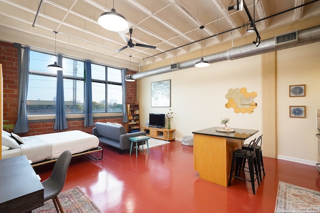 living room featuring ceiling fan and brick wall