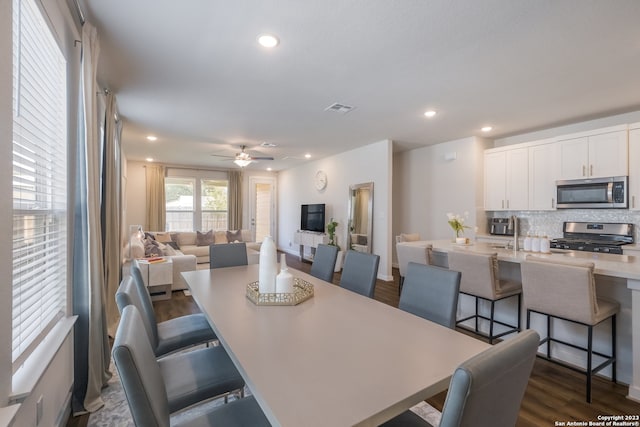 dining space with dark wood-type flooring and ceiling fan