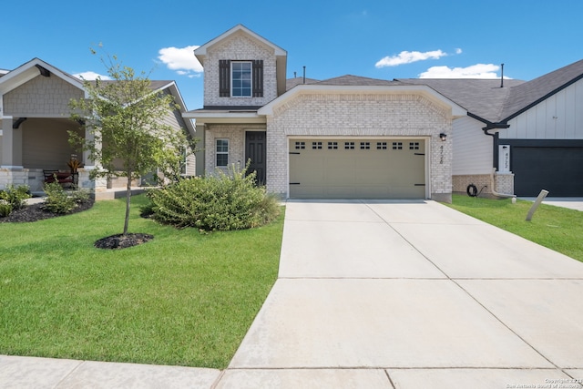 view of front of property featuring a front lawn and a garage