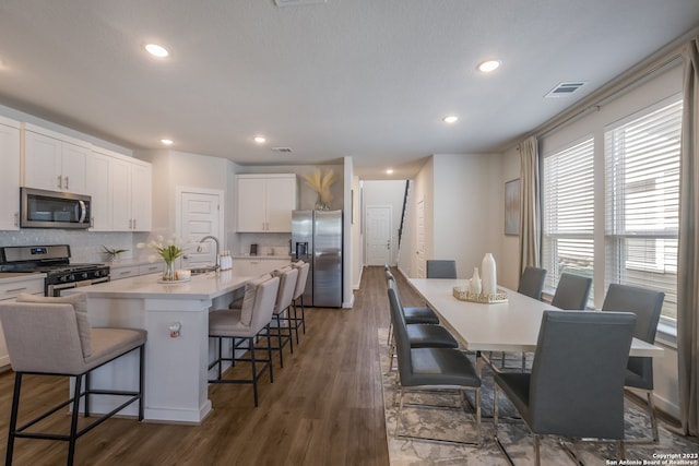 dining area featuring dark hardwood / wood-style flooring and sink