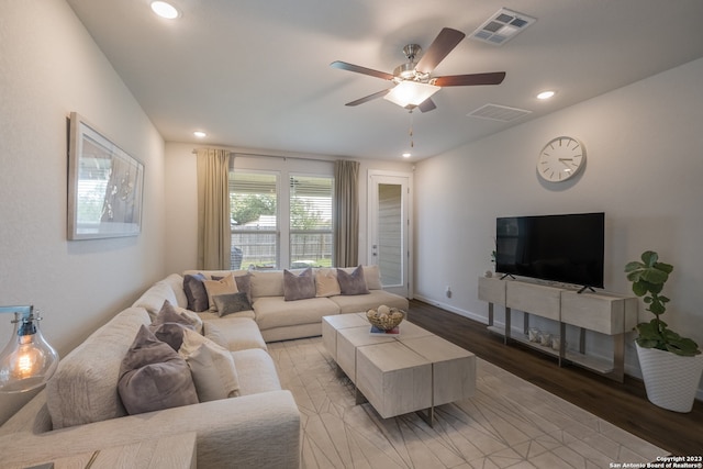 living room featuring ceiling fan and light hardwood / wood-style flooring