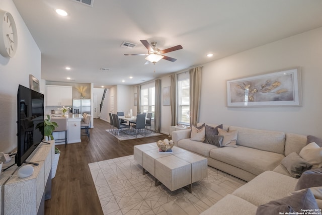 living room with ceiling fan and light wood-type flooring