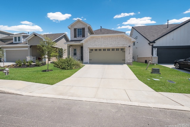 view of front of house featuring a front yard and a garage