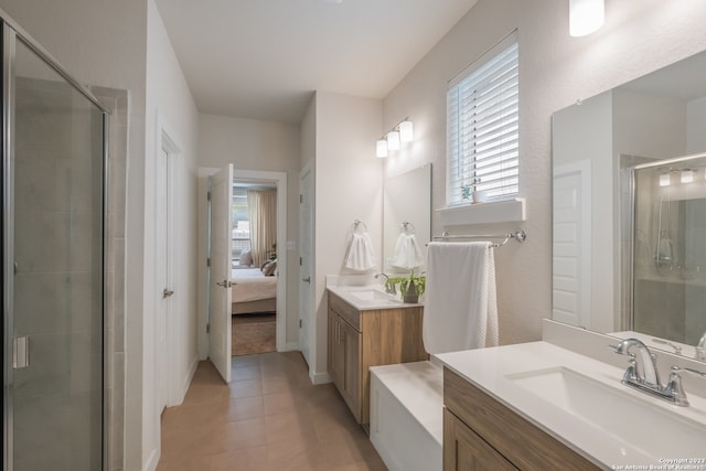 bathroom featuring walk in shower, tile floors, vanity, and a wealth of natural light