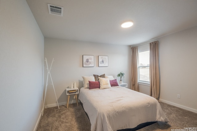 bedroom with dark carpet