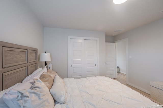 bedroom featuring a closet and light hardwood / wood-style flooring