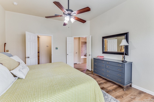 bedroom with wood-type flooring, ceiling fan, and ensuite bathroom