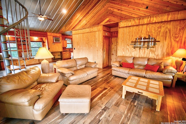 living room featuring lofted ceiling, ceiling fan, wood walls, hardwood / wood-style floors, and wood ceiling