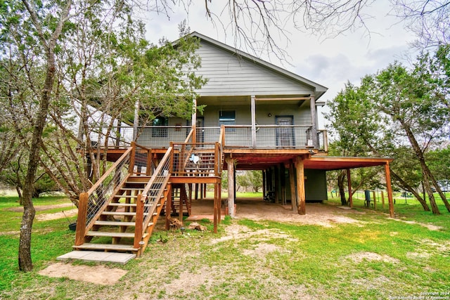 back of house with a carport and a lawn