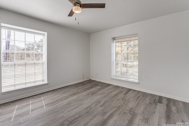 empty room featuring light hardwood / wood-style flooring and ceiling fan