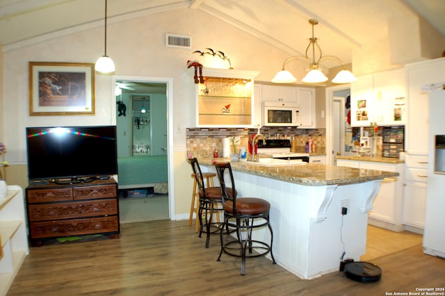 kitchen with range with electric cooktop, hanging light fixtures, and white cabinets