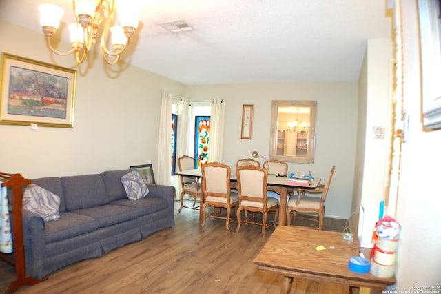 living room with a notable chandelier and hardwood / wood-style flooring