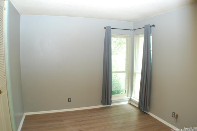 unfurnished room with light hardwood / wood-style flooring