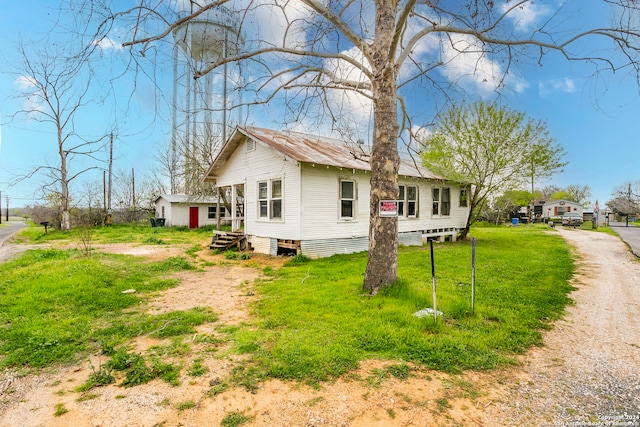 back of house with a yard