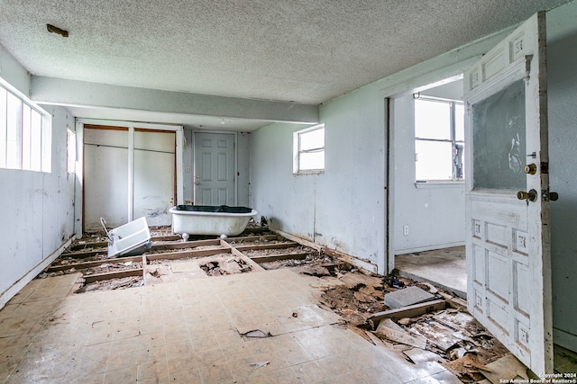 misc room with a textured ceiling and a wealth of natural light