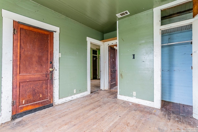 unfurnished bedroom featuring a closet and light hardwood / wood-style flooring