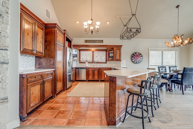 kitchen with light tile floors, a notable chandelier, tasteful backsplash, and stainless steel appliances