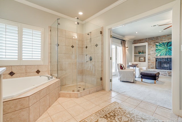 bathroom with tile floors, independent shower and bath, ceiling fan, a fireplace, and ornamental molding