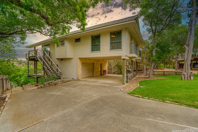 view of front of property with a lawn, a carport, and a garage