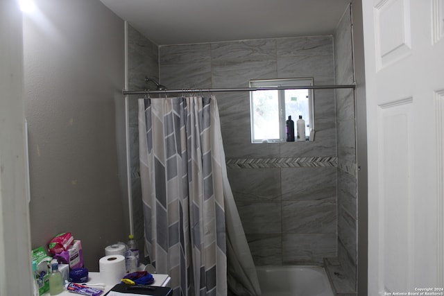 bathroom with shower / bathtub combination with curtain