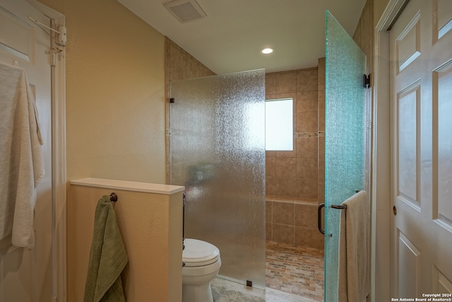 bathroom with walk in shower and toilet