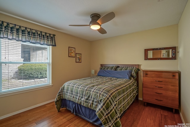 bedroom with ceiling fan and dark wood-type flooring