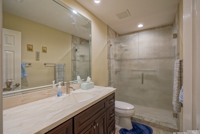 bathroom featuring an enclosed shower, vanity, and toilet