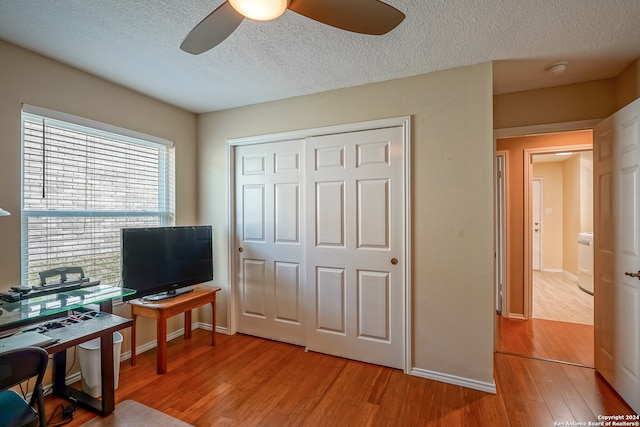 office space featuring ceiling fan, wood-type flooring, and a textured ceiling